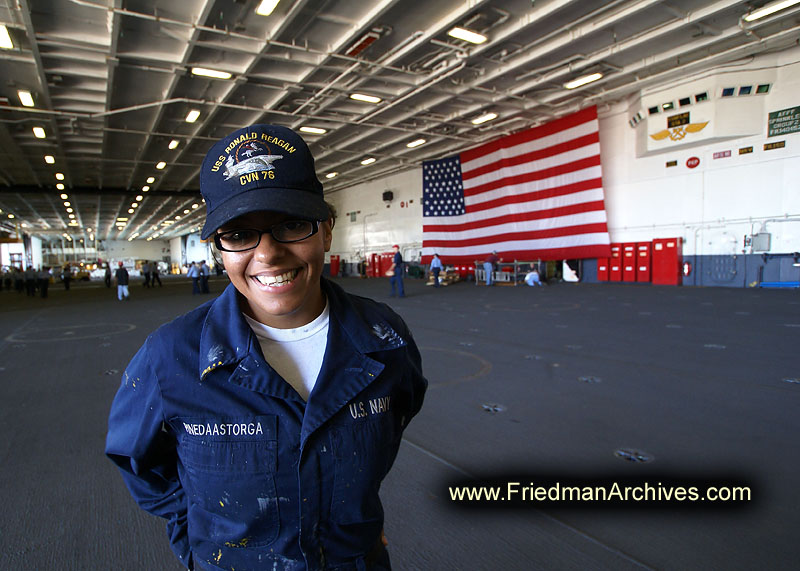 sailor,american flag,deck,smiling,aircraft,aircraft carrier,helicopter,maintenance,navy,ship,military,war ship