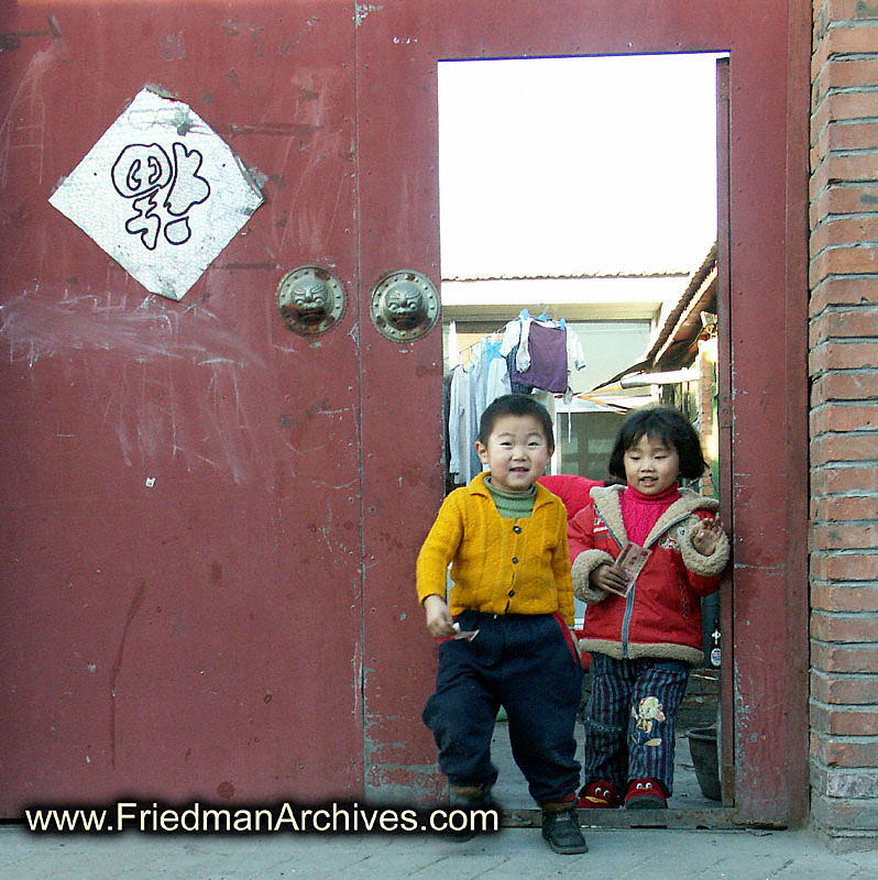 2 cute kids by door