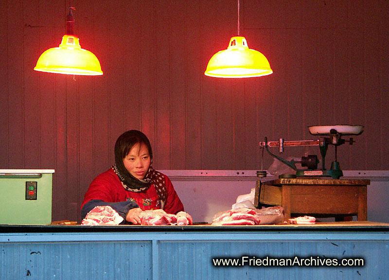 Women with scale and red wall