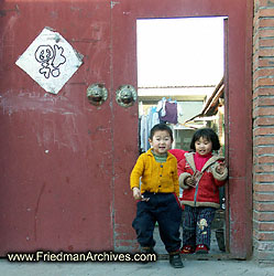 2 cute kids by door