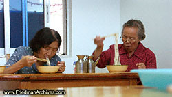 2 old ladies eating lo mein