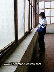 Girl standing by window