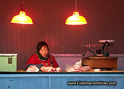 Women with scale and red wall