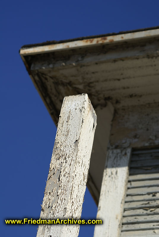 White post with peeling paint