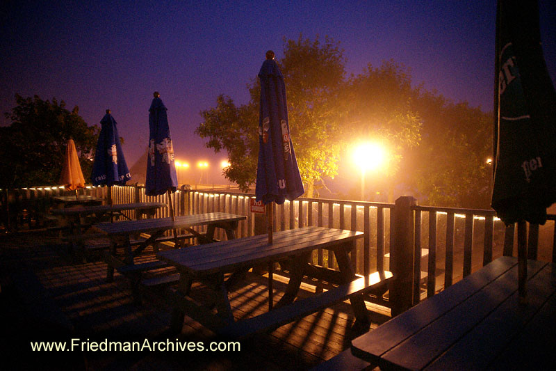 dusk,dawn,purple,sky,table,chairs,outdoor,dining,picnic,restaurant,deck,patio,evening,flood light,