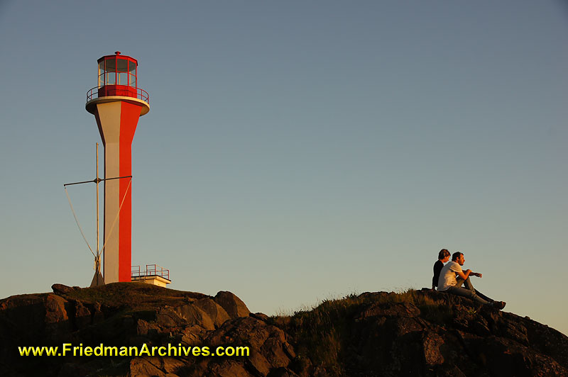 lighthouse,tourists,rocks,relaxing,sightseeing,