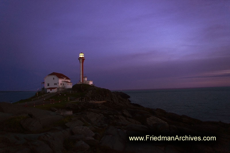 Lighthouse,Yarmouth,tourist,sunset,dusk,dawn,sunrise,purple,sky,rocks,