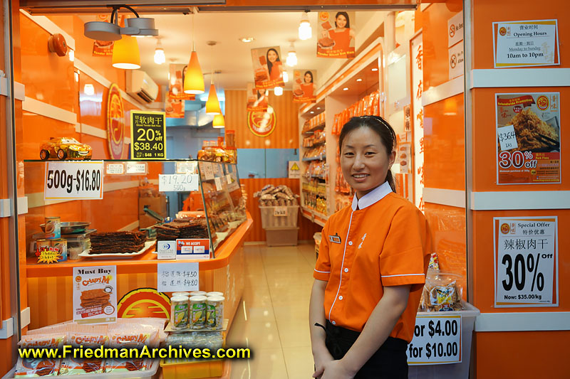 retail,meat,dried,jerky,worker,uniform,orange,environmental portrait,portrait,