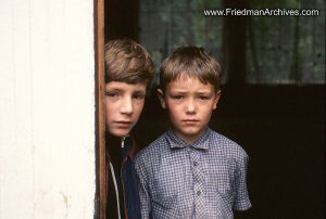 2 boys peeking around door