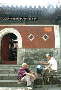 2 men in front of building