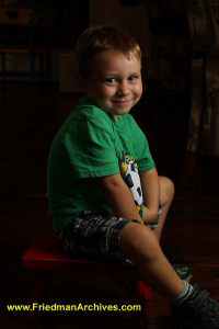 Boy Green Shirt Red Stool