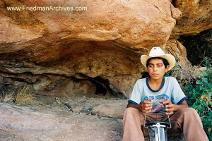 Boy with Hat near Rocks