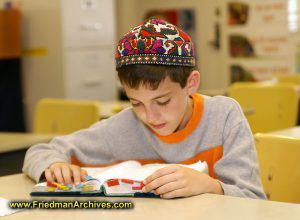 Boy with Orange Shirt Studying