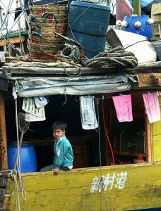 Boy at back of boat.