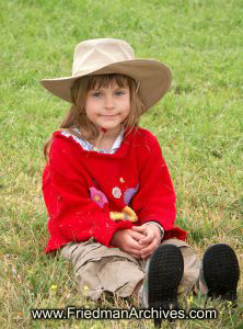 Girl on grass with red sweater