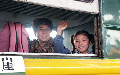 Girl_waving_from_train