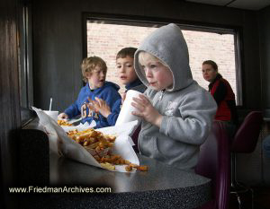 Kid eating Cheese Fries