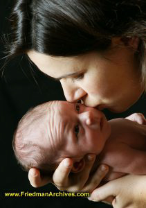 Mommy kissing newborn