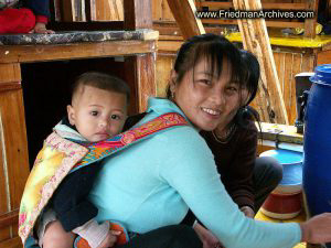 Mother and baby preparing chicken